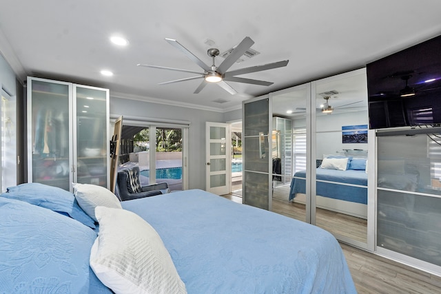 bedroom featuring french doors, light wood-type flooring, ceiling fan, and ornamental molding