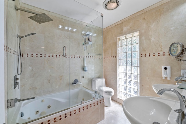 full bathroom with toilet, sink, and tile walls