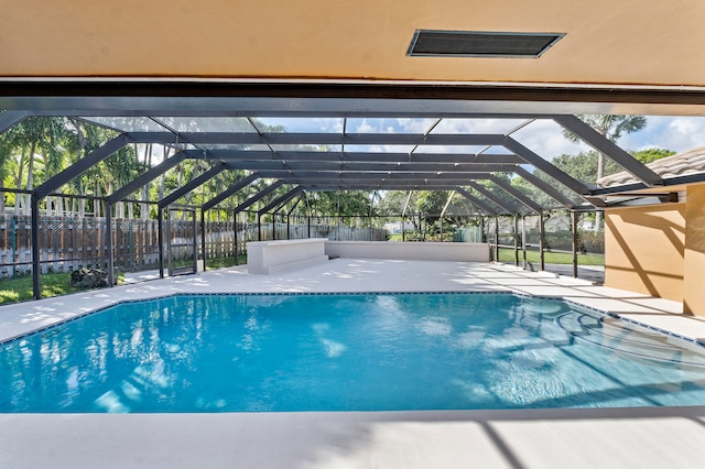 view of swimming pool featuring a lanai and a patio area