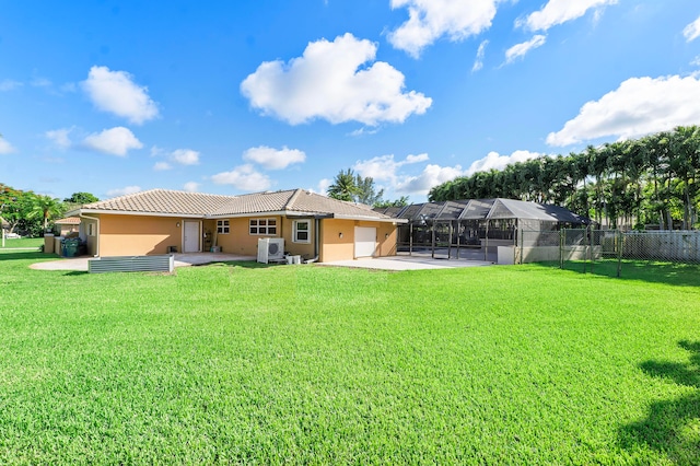 rear view of property with glass enclosure, a yard, a patio, and a garage