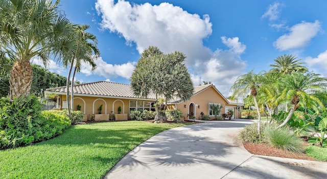 mediterranean / spanish-style house with a front lawn