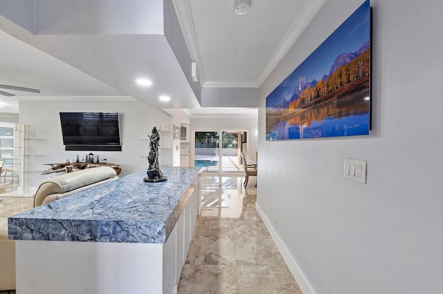 bar featuring white cabinets, ceiling fan, and ornamental molding