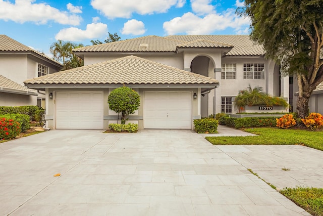 mediterranean / spanish house with a garage