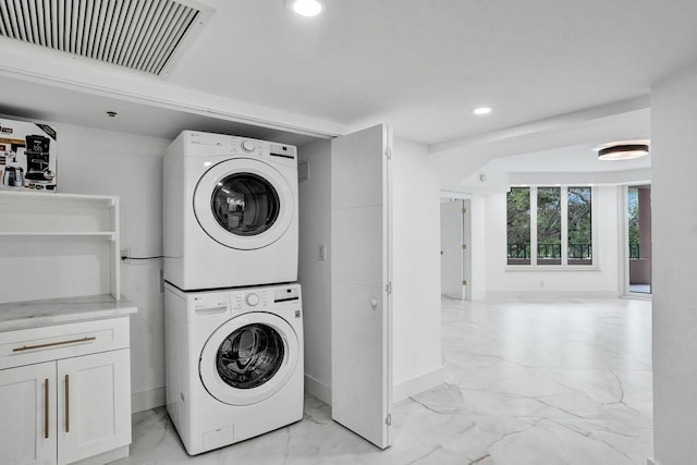 clothes washing area featuring stacked washer / drying machine