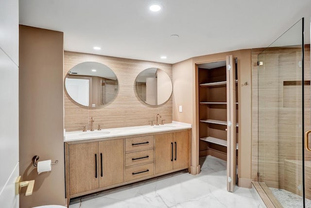 bathroom with vanity and a shower with shower door