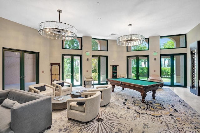 recreation room featuring a healthy amount of sunlight, billiards, and french doors