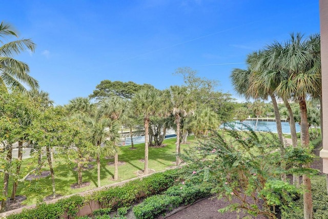 surrounding community with a yard and a water view