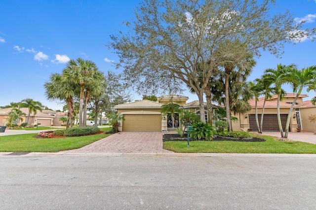 view of front of property with a garage and a front lawn