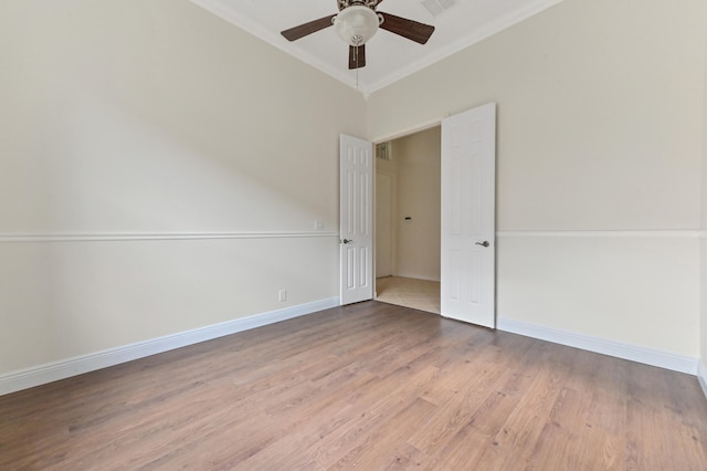 unfurnished room with ceiling fan, hardwood / wood-style floors, and ornamental molding