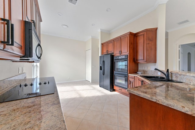 kitchen featuring light stone counters, ornamental molding, sink, black appliances, and light tile patterned flooring