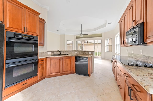 kitchen with kitchen peninsula, a tray ceiling, ceiling fan, sink, and black appliances