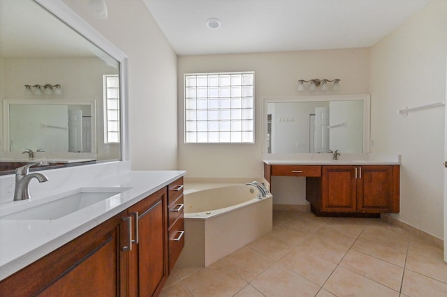 bathroom featuring tile patterned floors, a washtub, and vanity