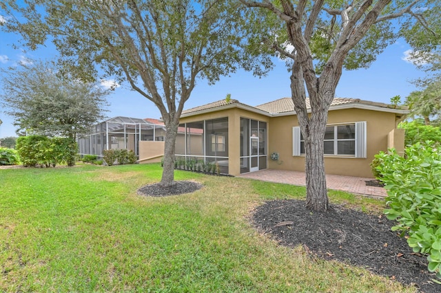 view of yard featuring a patio and a sunroom