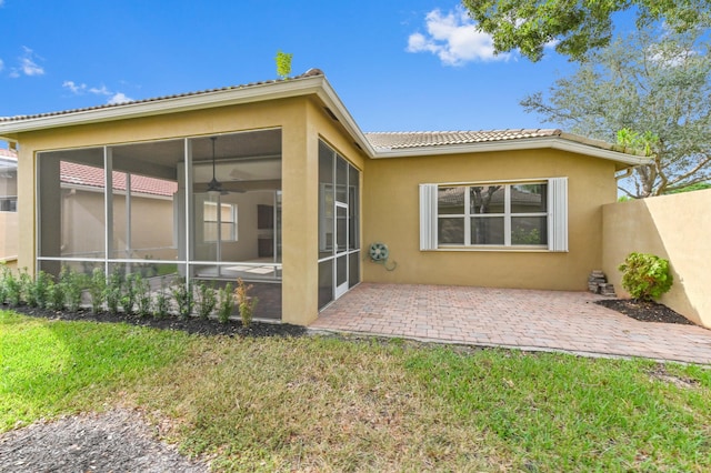 back of property featuring a patio area and a sunroom