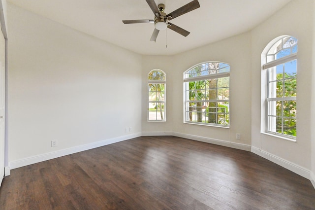 unfurnished room featuring ceiling fan and dark wood-type flooring