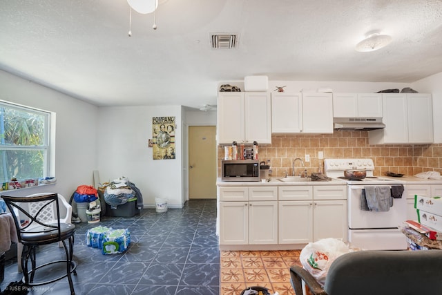 kitchen with white range with electric cooktop, backsplash, white cabinets, and sink