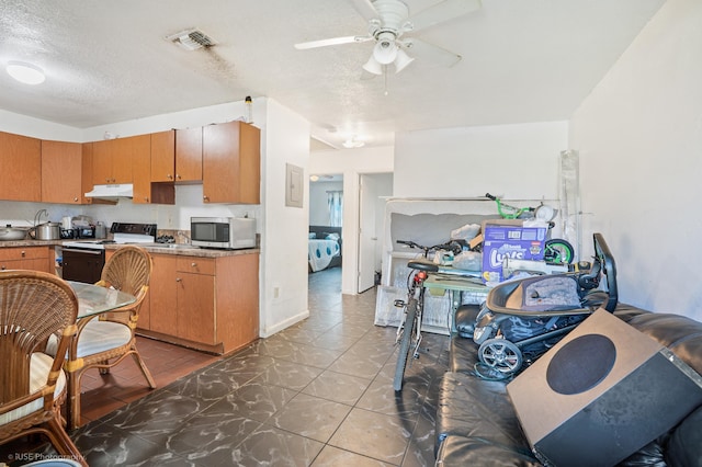 kitchen with electric range, ceiling fan, and a textured ceiling