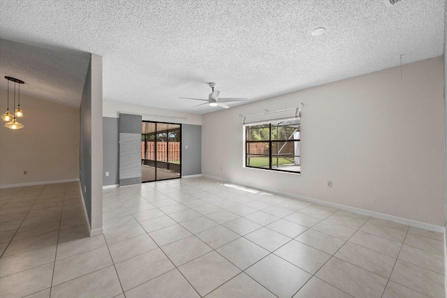 tiled empty room featuring ceiling fan and a textured ceiling