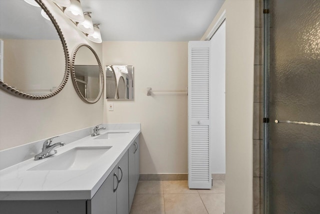 bathroom with tile patterned floors, a shower with door, and vanity