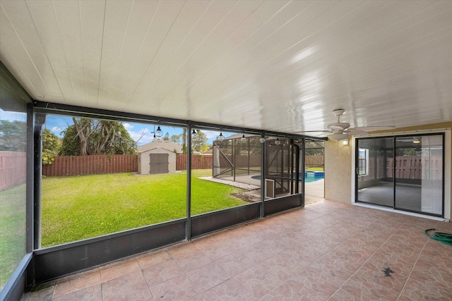 unfurnished sunroom with ceiling fan