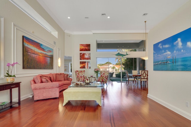 living room featuring hardwood / wood-style floors and ornamental molding