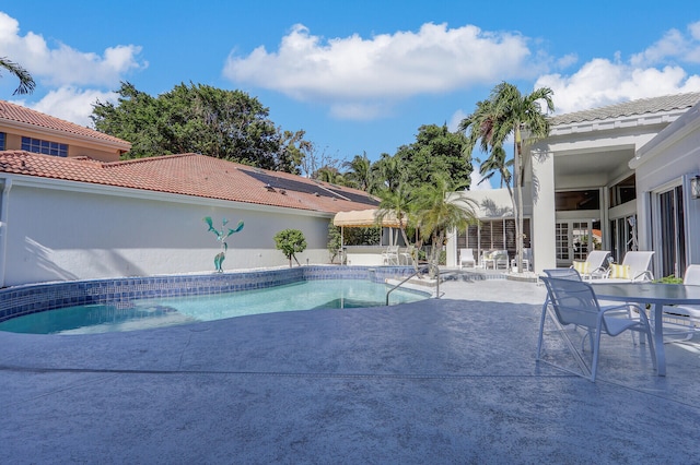 view of swimming pool featuring a patio area