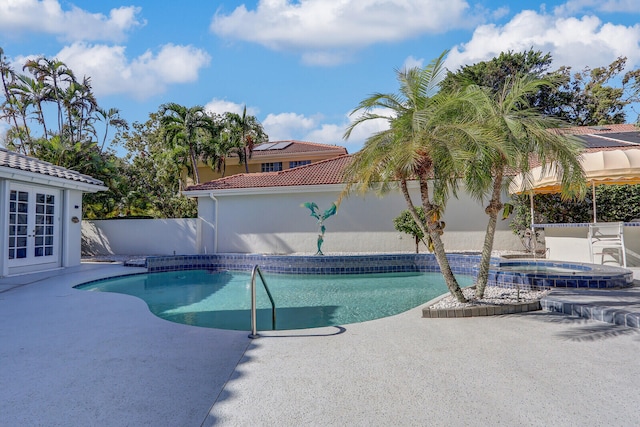 view of swimming pool featuring an in ground hot tub and a patio