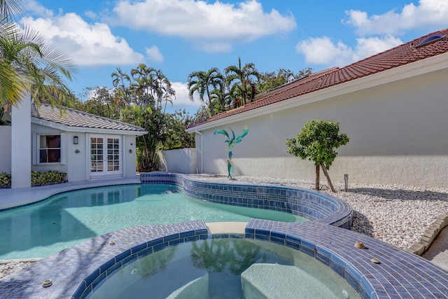 view of pool with an in ground hot tub