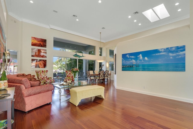 living room with a skylight, crown molding, and hardwood / wood-style flooring