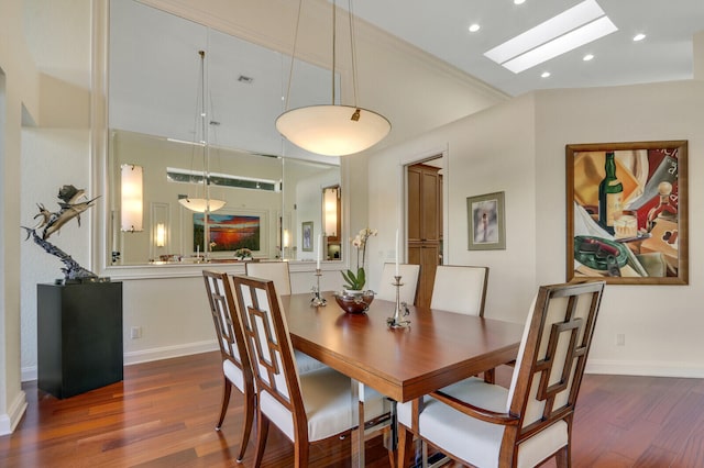 dining room featuring a skylight and dark hardwood / wood-style flooring