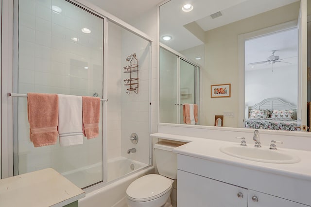 full bathroom featuring ceiling fan, vanity, combined bath / shower with glass door, and toilet