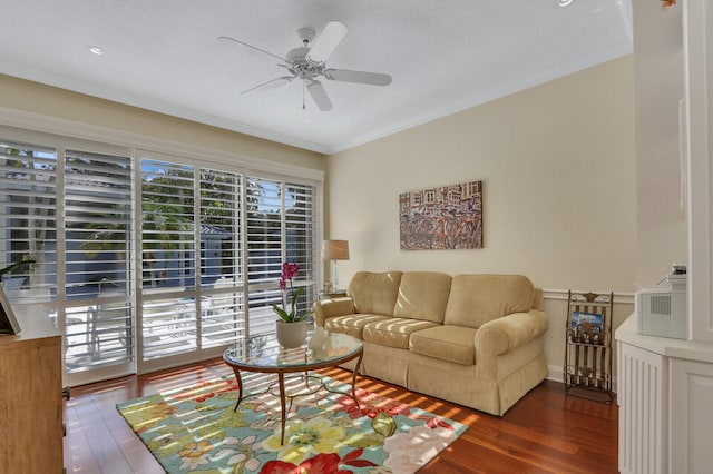 living room with dark hardwood / wood-style floors, a healthy amount of sunlight, crown molding, and ceiling fan