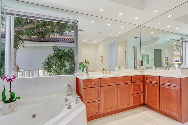 bathroom featuring vanity, plenty of natural light, and tiled tub