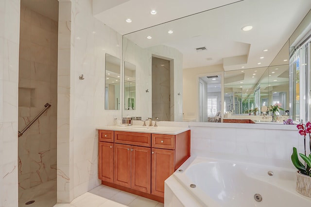 bathroom with tile patterned flooring, vanity, and independent shower and bath