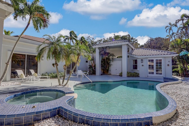 view of swimming pool with an in ground hot tub and a patio