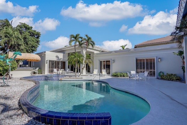 view of swimming pool with a patio