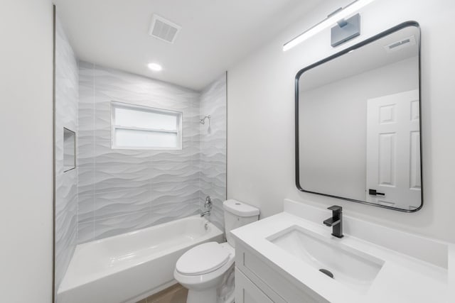 full bathroom featuring vanity, tiled shower / bath combo, and toilet