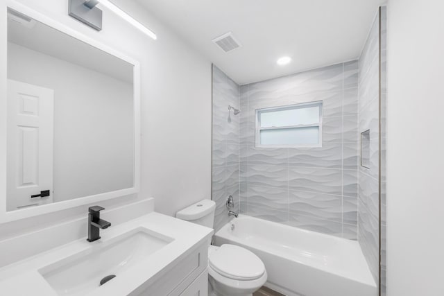 full bathroom featuring vanity, toilet, and tiled shower / bath