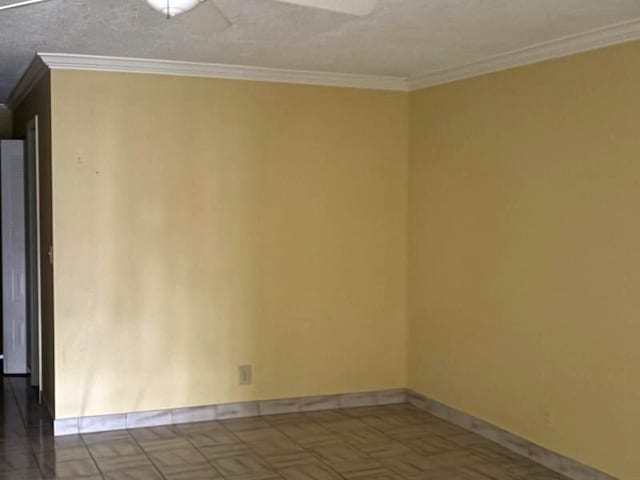 unfurnished room featuring a textured ceiling and crown molding