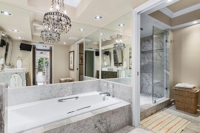 bathroom with ornamental molding, separate shower and tub, vanity, and an inviting chandelier