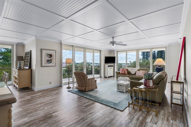 living room with wood-type flooring, plenty of natural light, ceiling fan, and a wall of windows