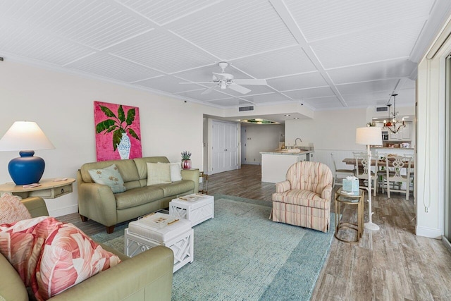 living room with ceiling fan, wood-type flooring, and sink