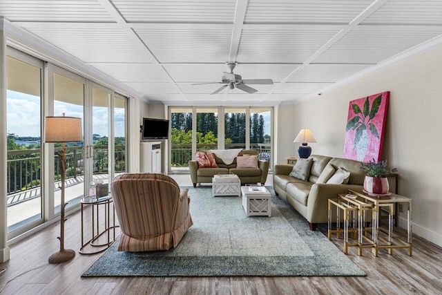 living room featuring hardwood / wood-style flooring, expansive windows, and ceiling fan