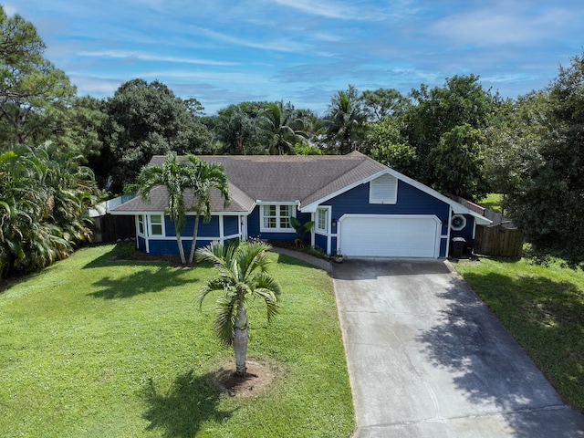 ranch-style home with a front yard and a garage