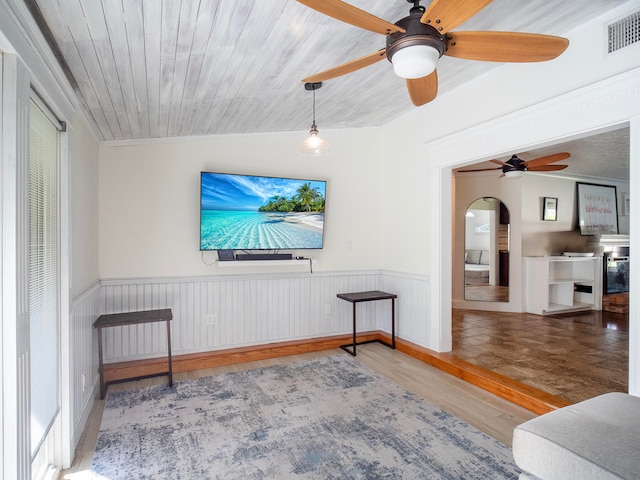 living room with ceiling fan, wooden ceiling, crown molding, hardwood / wood-style floors, and vaulted ceiling