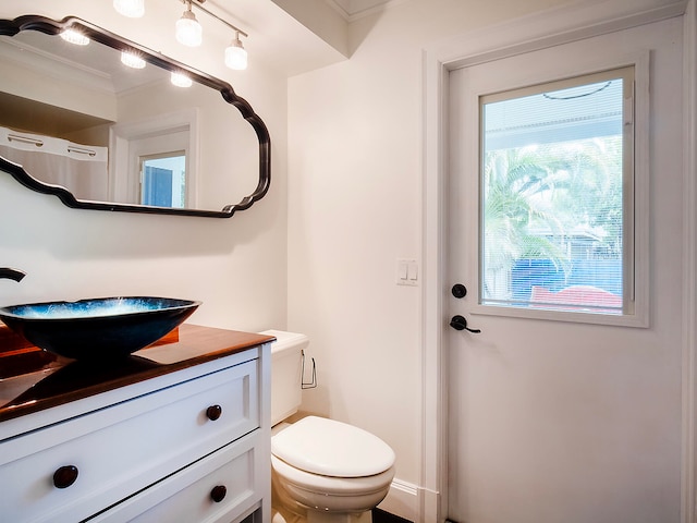 bathroom featuring crown molding, vanity, and toilet