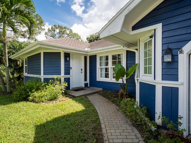 doorway to property featuring a yard