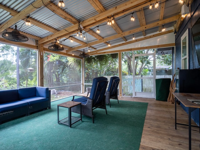 sunroom featuring vaulted ceiling with beams