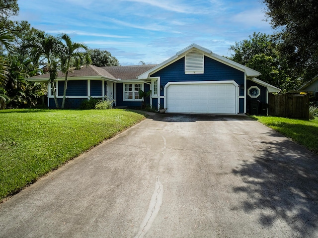 single story home featuring a front lawn and a garage