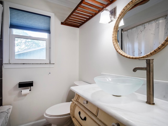 bathroom featuring vanity, curtained shower, and toilet